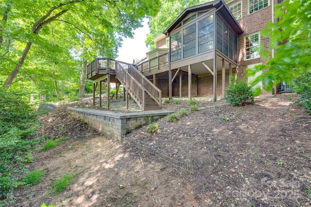 10215 Balmoral Cir, Charlotte, NC 28210 - back of house featuring stairs, a sunroom, a deck, and brick siding