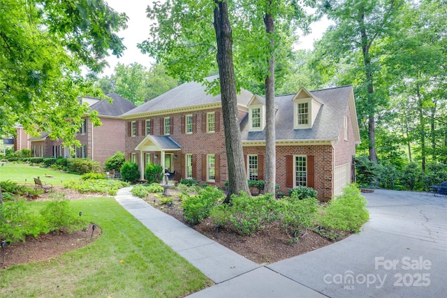 10215 Balmoral Cir, Charlotte, NC 28210 - colonial-style house with brick siding, a front yard, a garage, driveway, and roof with shingles