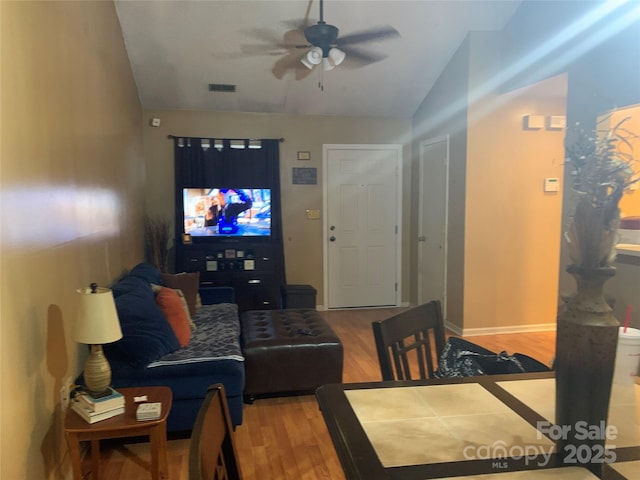 5816 Rocky Mount Ct, Charlotte, NC 28214 - living room featuring a ceiling fan, wood finished floors, vaulted ceiling, and baseboards