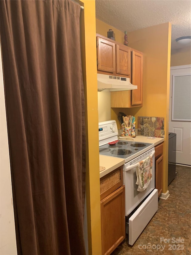 5816 Rocky Mount Ct, Charlotte, NC 28214 - kitchen featuring white range with electric stovetop, under cabinet range hood, a textured ceiling, washer / clothes dryer, and light countertops