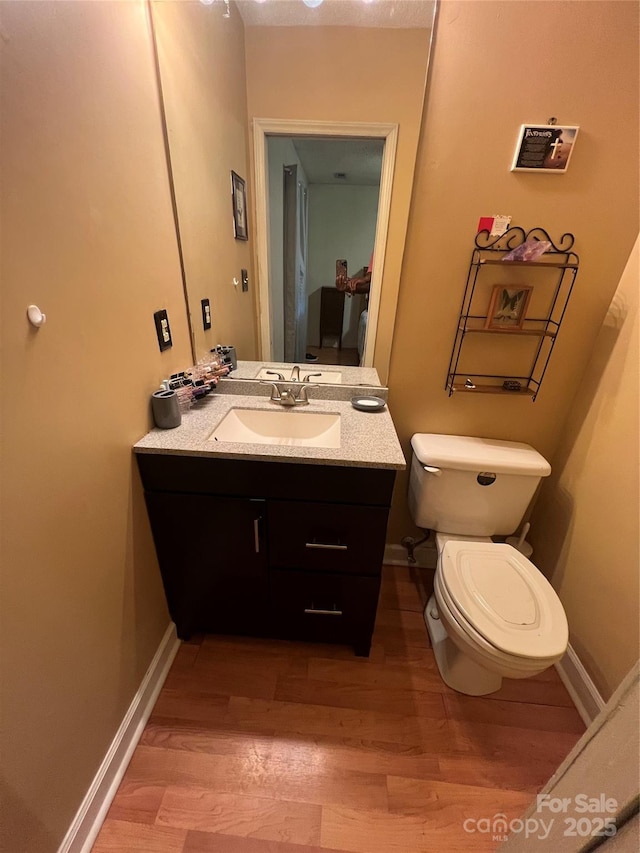 5816 Rocky Mount Ct, Charlotte, NC 28214 - bathroom featuring wood finished floors, toilet, vanity, and baseboards