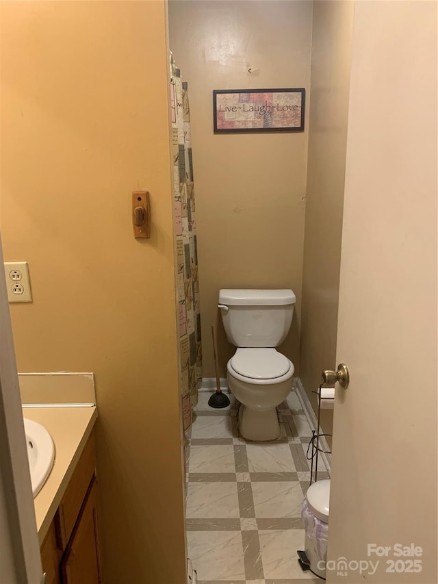 5816 Rocky Mount Ct, Charlotte, NC 28214 - full bathroom with toilet, vanity, and baseboards
