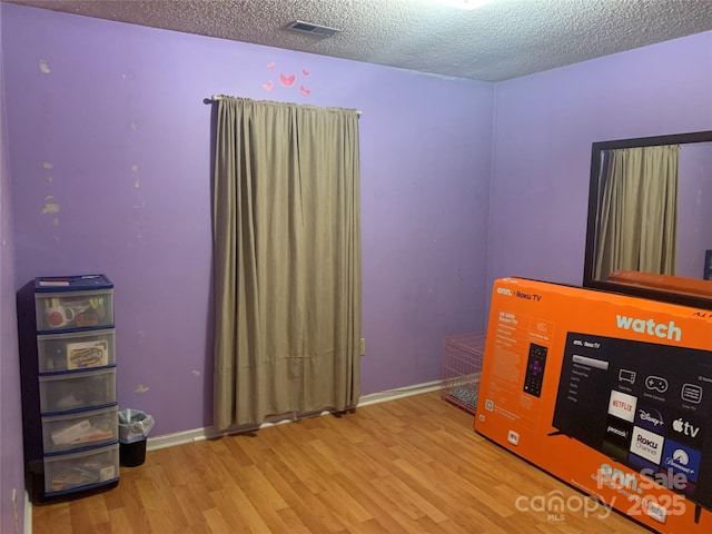 5816 Rocky Mount Ct, Charlotte, NC 28214 - unfurnished bedroom featuring wood finished floors, a textured ceiling, and baseboards