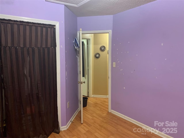 5816 Rocky Mount Ct, Charlotte, NC 28214 - bedroom with light wood-style floors, baseboards, and a textured ceiling