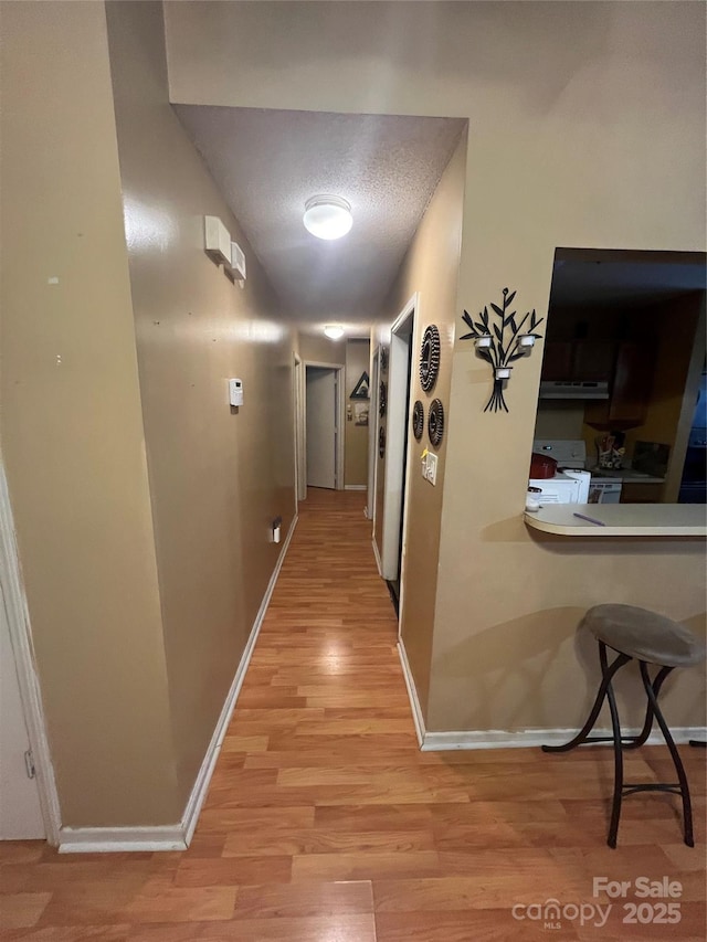 5816 Rocky Mount Ct, Charlotte, NC 28214 - corridor with light wood-style floors, a desk, and baseboards