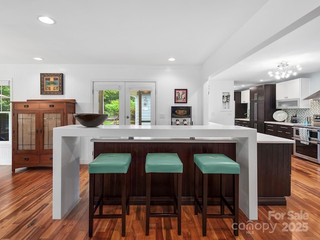1165 Mountain Laurel Dr, Columbus, NC 28722 - kitchen with light countertops, plenty of natural light, tasteful backsplash, wood finished floors, and recessed lighting