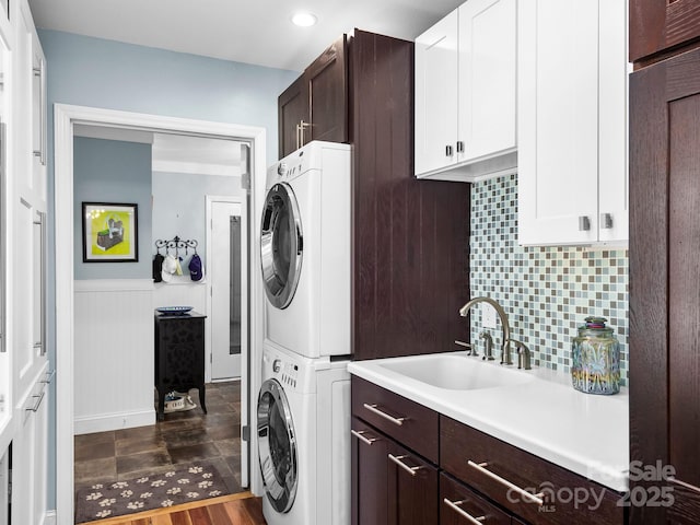 1165 Mountain Laurel Dr, Columbus, NC 28722 - laundry area featuring estacked washer and dryer, cabinet space, wainscoting, recessed lighting, and wood finished floors