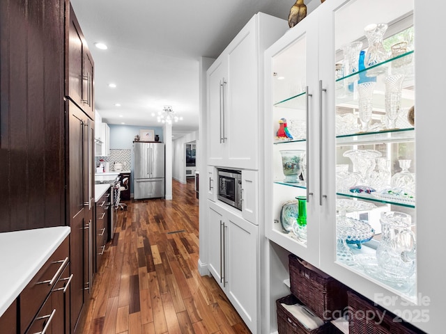 1165 Mountain Laurel Dr, Columbus, NC 28722 - kitchen with appliances with stainless steel finishes, light countertops, dark brown cabinetry, dark wood-style flooring, and white cabinets