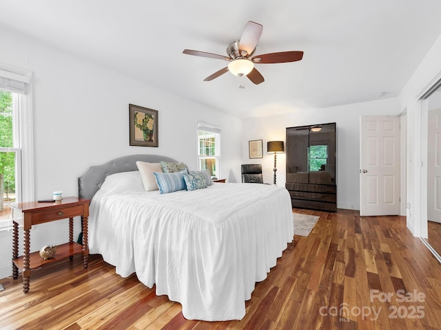 1165 Mountain Laurel Dr, Columbus, NC 28722 - bedroom with multiple windows, wood finished floors, and a ceiling fan