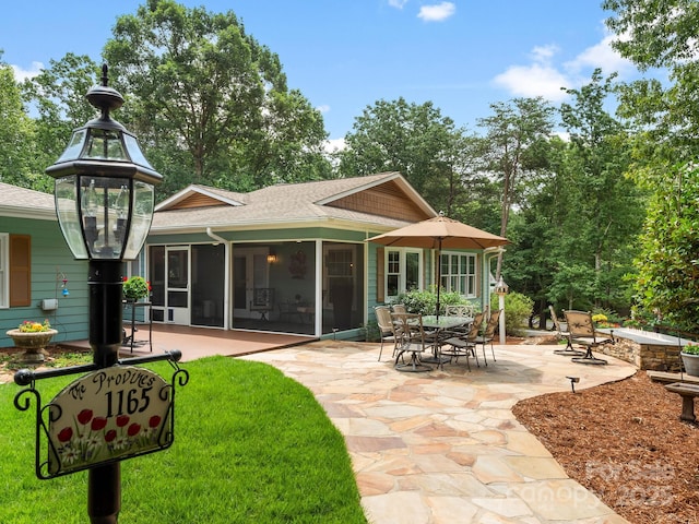 1165 Mountain Laurel Dr, Columbus, NC 28722 - back of property with a patio area, a shingled roof, and a sunroom