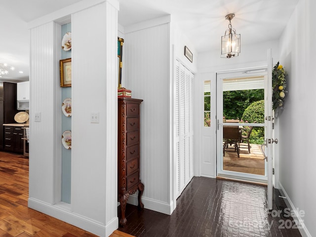 1165 Mountain Laurel Dr, Columbus, NC 28722 - foyer with baseboards, a chandelier, and dark wood-type flooring