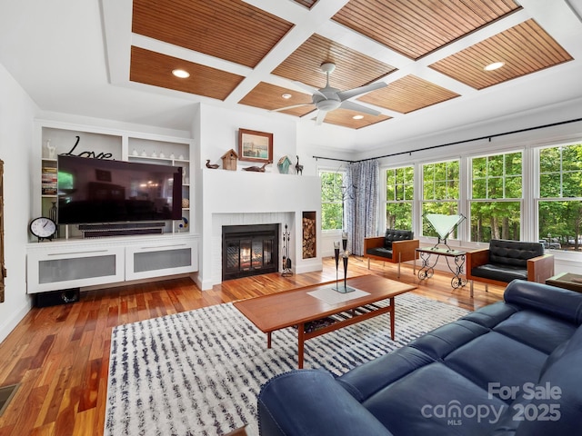 1165 Mountain Laurel Dr, Columbus, NC 28722 - living area with a fireplace, coffered ceiling, ceiling fan, built in shelves, and wood finished floors