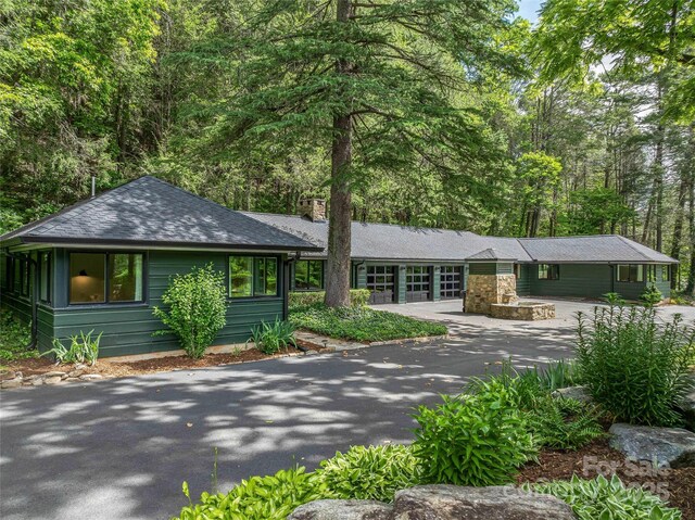 400 Kings Dr, Lake Lure, NC 28746 - view of front facade with a chimney and roof with shingles