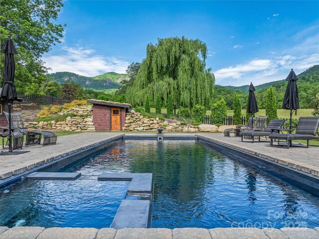 400 Kings Dr, Lake Lure, NC 28746 - view of pool with a mountain view, a patio, and a pool with connected hot tub