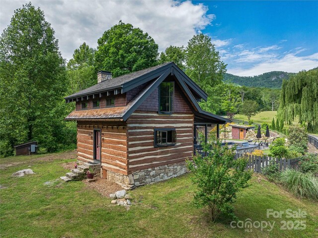 400 Kings Dr, Lake Lure, NC 28746 - view of side of property with a chimney and an outbuilding
