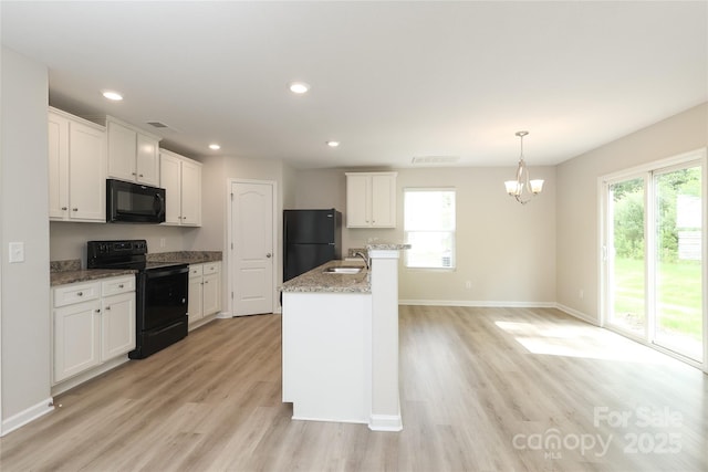 3349 Ellingford Rd, Charlotte, NC 28214 - kitchen with black appliances, light wood-style floors, healthy amount of natural light, and recessed lighting