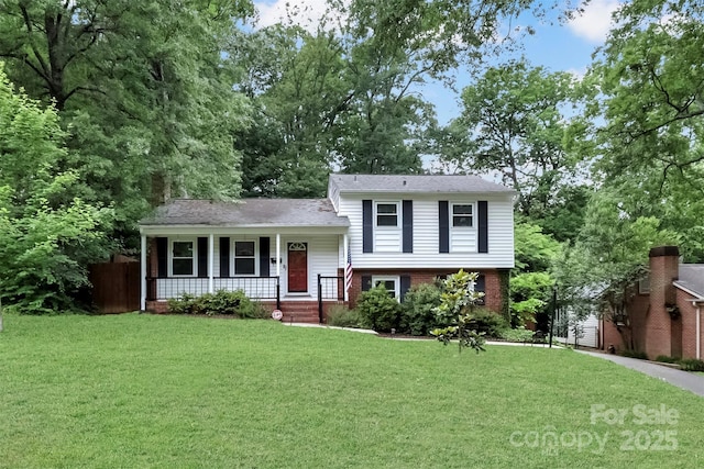 3624 Moultrie St, Charlotte, NC 28209 - split level home featuring covered porch, a front lawn, and brick siding