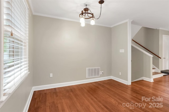 3624 Moultrie St, Charlotte, NC 28209 - unfurnished room with wood finished floors, baseboards, ornamental molding, a chandelier, and stairs