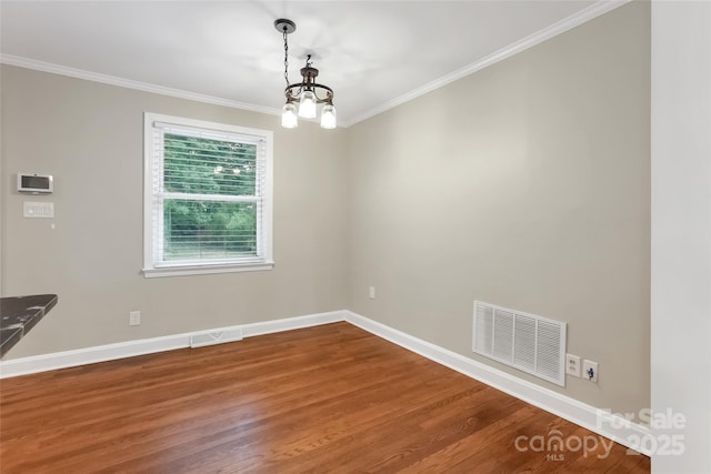 3624 Moultrie St, Charlotte, NC 28209 - unfurnished dining area with wood finished floors, crown molding, a chandelier, and baseboards