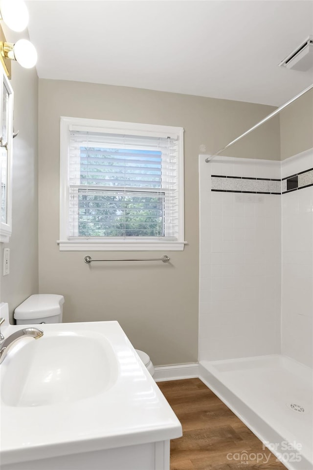 3624 Moultrie St, Charlotte, NC 28209 - full bath featuring a tile shower, wood finished floors, and vanity
