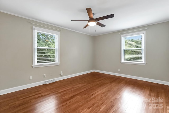 3624 Moultrie St, Charlotte, NC 28209 - spare room featuring plenty of natural light, a ceiling fan, ornamental molding, wood finished floors, and baseboards