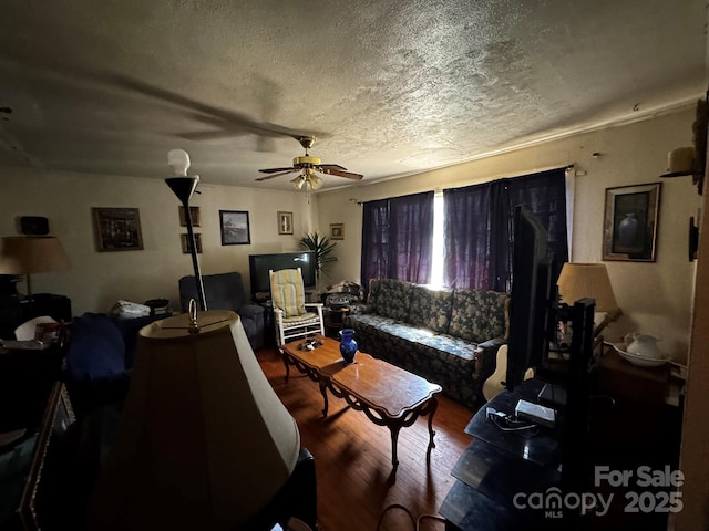 537 Beall St NW, Lenoir, NC 28645 - living area with wood finished floors, ceiling fan, and a textured ceiling