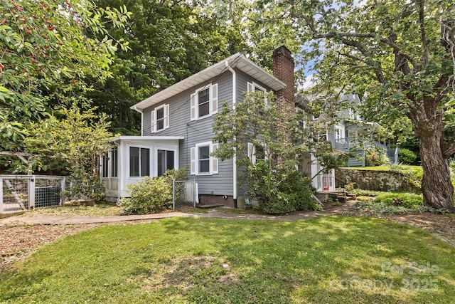 20 Kenilwood Pl, Asheville, NC 28803 - rear view of property with a chimney, a lawn, and a sunroom