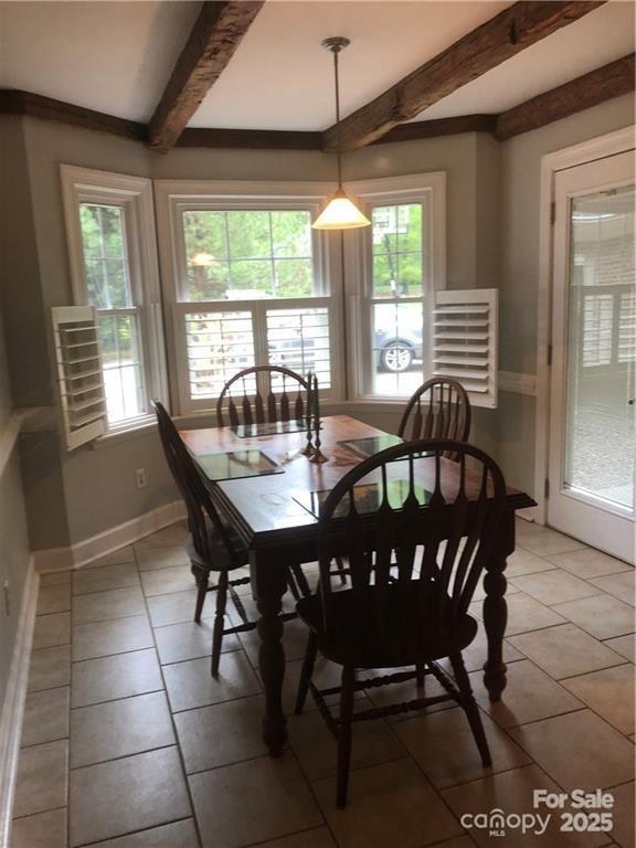 1619 Bellamy Cir, Albemarle, NC 28001 - dining room featuring beam ceiling, light tile patterned flooring, and baseboards