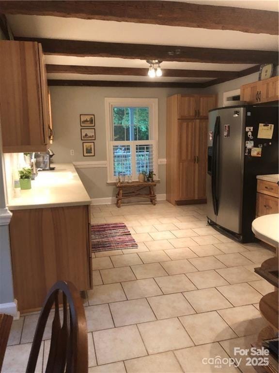 1619 Bellamy Cir, Albemarle, NC 28001 - kitchen featuring black refrigerator with ice dispenser, light countertops, beamed ceiling, brown cabinets, and light tile patterned flooring