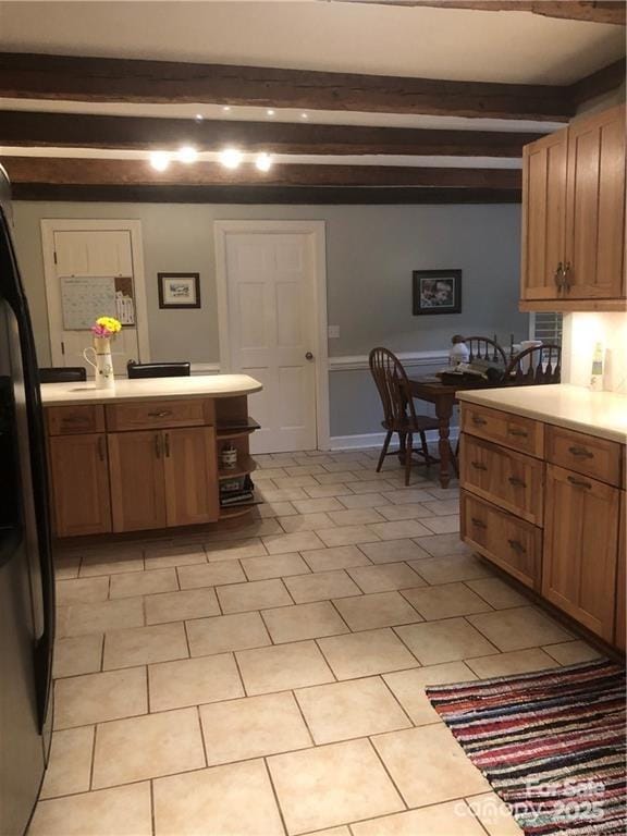 1619 Bellamy Cir, Albemarle, NC 28001 - kitchen with beamed ceiling, light countertops, freestanding refrigerator, brown cabinetry, and a peninsula