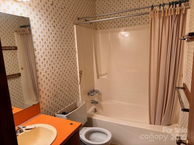 6561 Weldon Cir NW, Concord, NC 28027 - full bathroom featuring wallpapered walls, shower / tub combo, vanity, and toilet