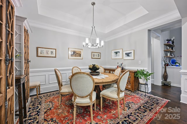 5118 Waldron Meadow Dr, Charlotte, NC 28226 - dining area with a chandelier, a raised ceiling, dark wood-style floors, crown molding, and a wainscoted wall