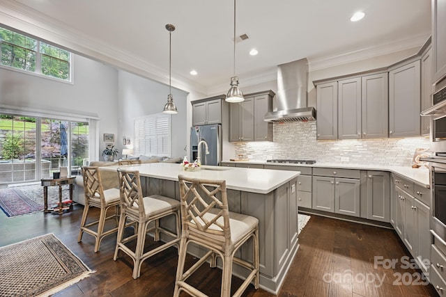 5118 Waldron Meadow Dr, Charlotte, NC 28226 - kitchen with gray cabinets, wall chimney range hood, appliances with stainless steel finishes, light countertops, and ornamental molding
