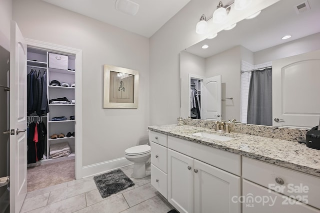 5118 Waldron Meadow Dr, Charlotte, NC 28226 - bathroom featuring a walk in closet, vanity, toilet, baseboards, and a shower with curtain