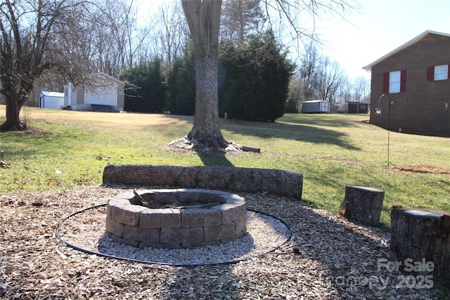 2653 Fairway Acres Cir, Lenoir, NC 28645 - view of grassy yard with a fire pit and a shed