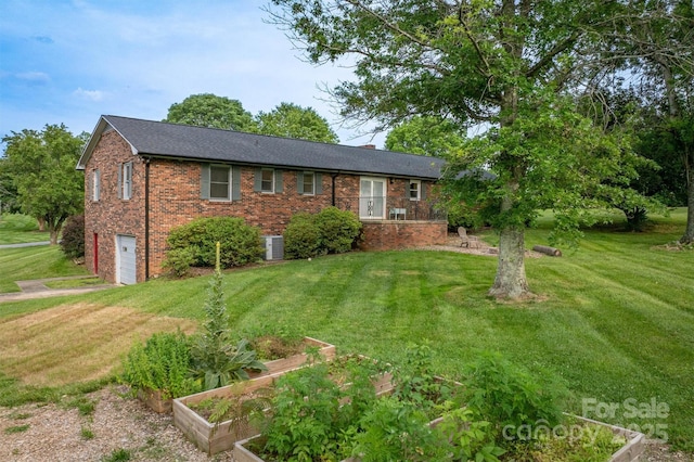 2653 Fairway Acres Cir, Lenoir, NC 28645 - view of front of house with a garden, a garage, a front yard, and brick siding