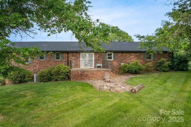 2653 Fairway Acres Cir, Lenoir, NC 28645 - view of front of home with a fire pit, brick siding, a front yard, and roof with shingles