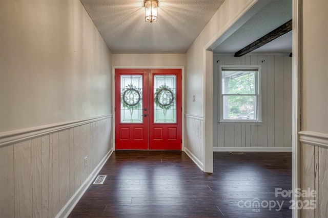 2653 Fairway Acres Cir, Lenoir, NC 28645 - foyer entrance featuring wood-type flooring, a textured ceiling, wooden walls, and french doors