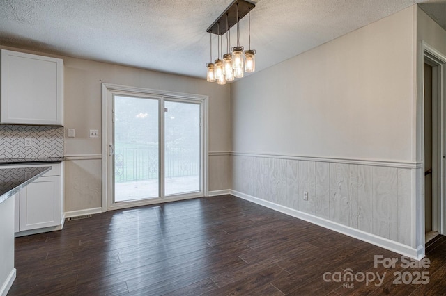 2653 Fairway Acres Cir, Lenoir, NC 28645 - unfurnished dining area featuring dark wood finished floors, a chandelier, and a textured ceiling