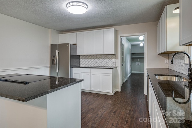 2653 Fairway Acres Cir, Lenoir, NC 28645 - kitchen featuring stainless steel fridge with ice dispenser, dark stone countertops, dark wood finished floors, tasteful backsplash, and a textured ceiling
