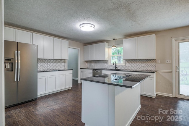 2653 Fairway Acres Cir, Lenoir, NC 28645 - kitchen with stainless steel appliances, dark wood-type flooring, white cabinetry, backsplash, and a textured ceiling