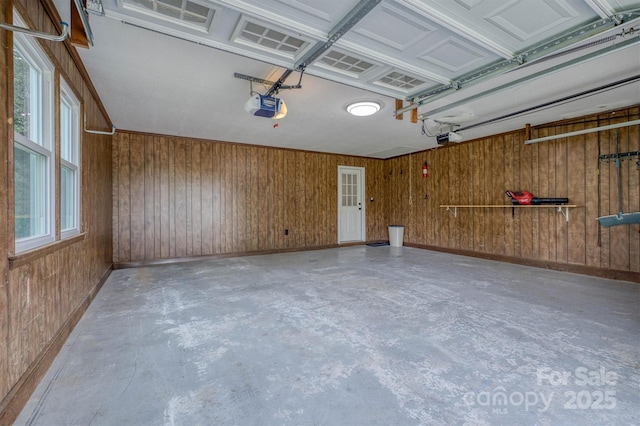 2653 Fairway Acres Cir, Lenoir, NC 28645 - garage featuring a garage door opener and wood walls