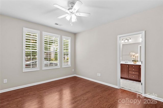 18339 The Commons Blvd, Cornelius, NC 28031 - unfurnished bedroom with dark wood-style floors, baseboards, a sink, and ensuite bathroom