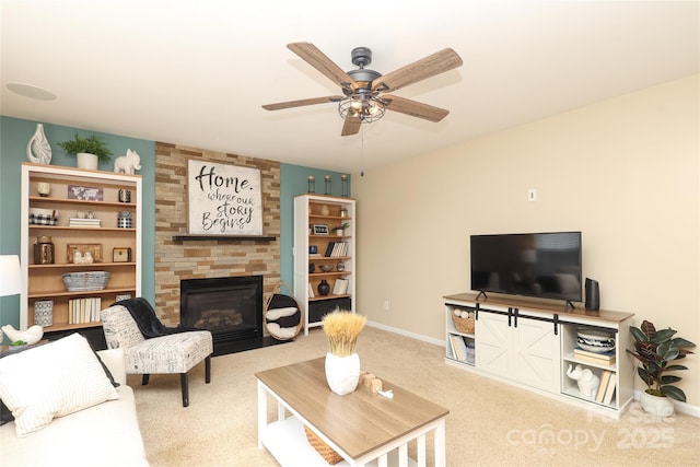 2018 Rosewater Ln, Indian Trail, NC 28079 - carpeted living room with a large fireplace, a ceiling fan, and baseboards