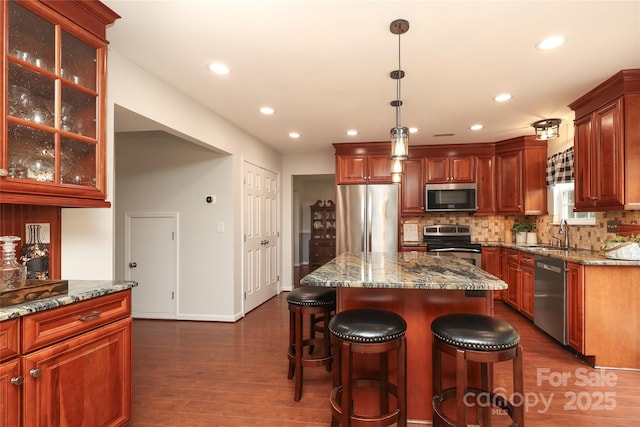 2018 Rosewater Ln, Indian Trail, NC 28079 - kitchen featuring stainless steel appliances, a sink, tasteful backsplash, dark wood finished floors, and stone counters