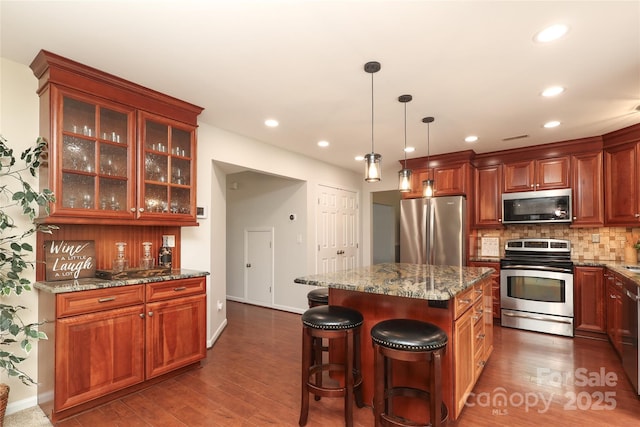 2018 Rosewater Ln, Indian Trail, NC 28079 - kitchen featuring stainless steel appliances, backsplash, dark wood-type flooring, glass insert cabinets, and recessed lighting