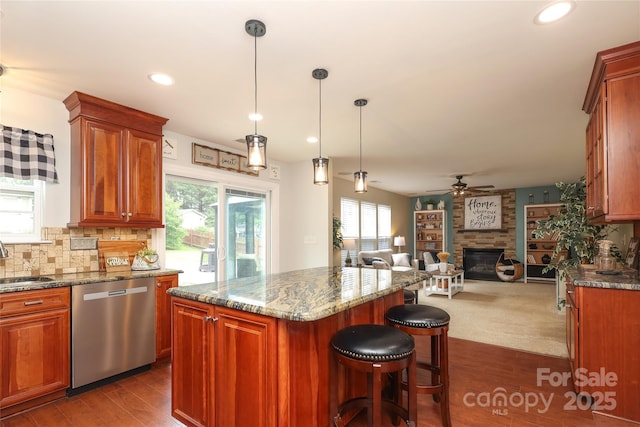 2018 Rosewater Ln, Indian Trail, NC 28079 - kitchen featuring dishwasher, a sink, dark wood finished floors, a kitchen island, and a large fireplace