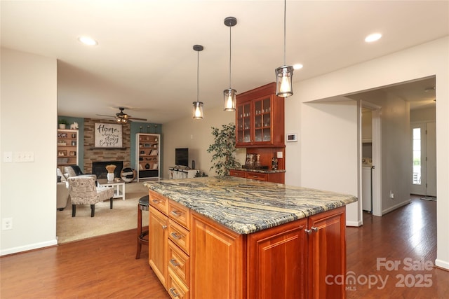 2018 Rosewater Ln, Indian Trail, NC 28079 - kitchen with a ceiling fan, dark wood-style floors, a kitchen island, a fireplace, and recessed lighting