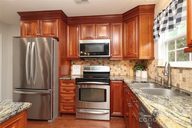 2018 Rosewater Ln, Indian Trail, NC 28079 - kitchen featuring stainless steel appliances, a sink, dark stone counters, and backsplash