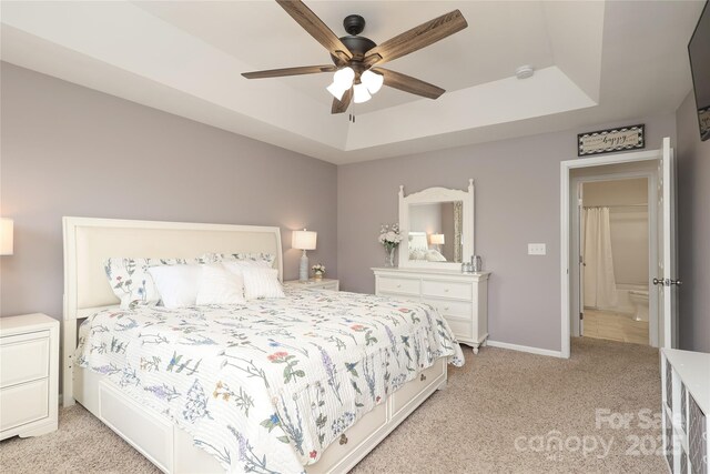 2018 Rosewater Ln, Indian Trail, NC 28079 - bedroom with a tray ceiling, light carpet, a ceiling fan, and baseboards